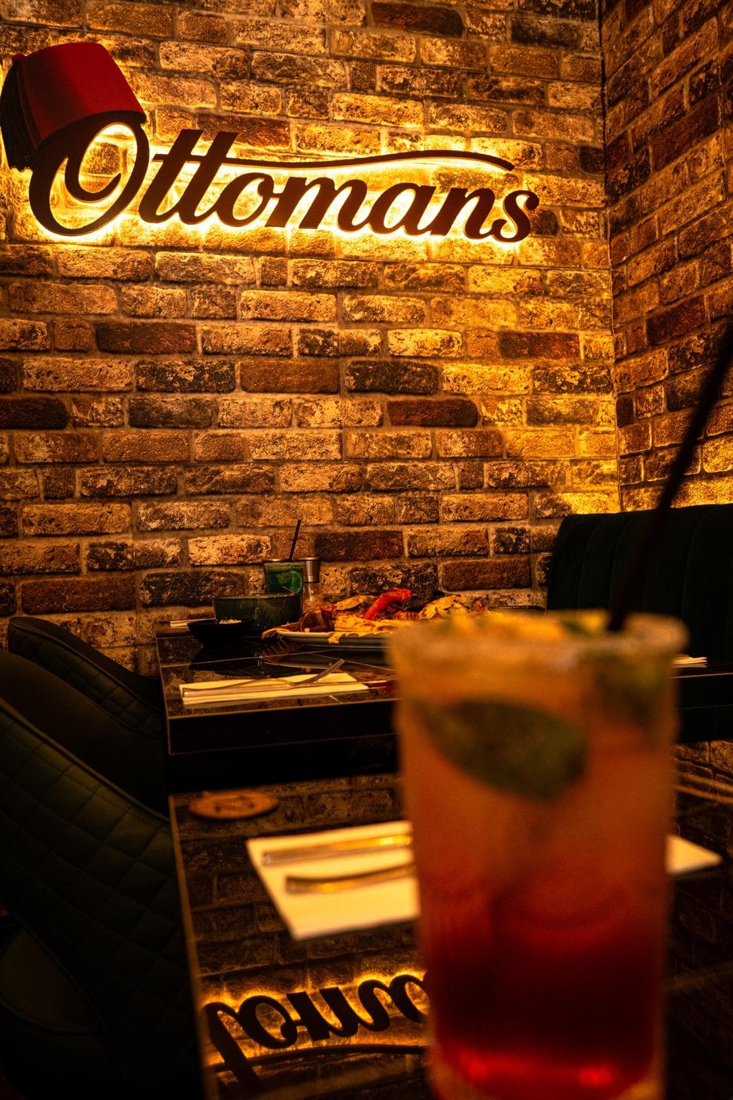 Inside Ottomans, under the backlit sign